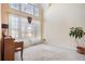 Bright foyer with large windows, piano, neutral carpet, and potted plant at 2118 Sableshire Se Way, Conyers, GA 30013