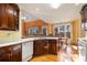 Spacious kitchen with wooden cabinets, stainless steel appliances, and a view into the dining area at 2118 Sableshire Se Way, Conyers, GA 30013
