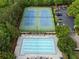 Aerial shot of the community pool and tennis courts nestled among mature trees at 215 Scott Xing, Roswell, GA 30076