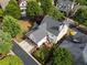 Aerial view of the home showcasing the backyard, patio, and surrounding landscape at 215 Scott Xing, Roswell, GA 30076