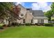Expansive backyard with lush lawn, mature trees, and well-maintained landscaping at 215 Scott Xing, Roswell, GA 30076