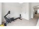 Bonus room features a rowing machine and neutral carpet at 215 Scott Xing, Roswell, GA 30076