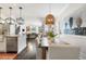 Bright dining area with a large wooden table, pendant light, and art at 215 Scott Xing, Roswell, GA 30076