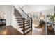 View of the stairway with iron spindles, hardwood floors, and entry to living space at 215 Scott Xing, Roswell, GA 30076