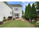 Back exterior of home with garden and manicured lawn at 215 Scott Xing, Roswell, GA 30076