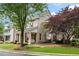 Charming brick home with a welcoming front porch and well-manicured lawn at 215 Scott Xing, Roswell, GA 30076