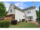 Back exterior of home featuring brick patio, garden, and garage at 215 Scott Xing, Roswell, GA 30076