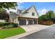 Triple garage with covered lattice and green lawn at 215 Scott Xing, Roswell, GA 30076
