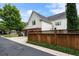 Triple garage with lush landscaping and covered lattice at 215 Scott Xing, Roswell, GA 30076