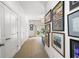 Inviting hallway with neutral carpet and decorated with attractive framed prints and wall sconces at 215 Scott Xing, Roswell, GA 30076