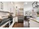 Stylish kitchen with stainless steel appliances and adjoining living area at 215 Scott Xing, Roswell, GA 30076