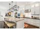 Modern kitchen features a large island with seating and black pendant lighting at 215 Scott Xing, Roswell, GA 30076