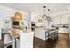 Modern kitchen with white cabinets, granite countertops, stainless steel appliances, and island seating at 215 Scott Xing, Roswell, GA 30076