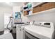 Well-organized laundry room with modern washer and dryer and practical built-in shelving at 215 Scott Xing, Roswell, GA 30076