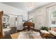 Formal living room with piano, decor, chandelier, hardwood floors, and large windows at 215 Scott Xing, Roswell, GA 30076