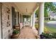 Inviting front porch with a swing, seating, and decorative columns at 215 Scott Xing, Roswell, GA 30076