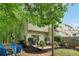 Charming backyard featuring a patio, fire pit with blue chairs, lush landscaping, and privacy fence at 3618 Berkeley Ct # Iv-A, Duluth, GA 30096