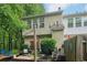 Backyard patio with seating, lush greenery, privacy fence, and string lights providing a cozy outdoor atmosphere at 3618 Berkeley Ct # Iv-A, Duluth, GA 30096