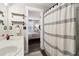 Bathroom with curtained shower, shelving, and entry to bedroom at 3618 Berkeley Ct # Iv-A, Duluth, GA 30096