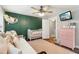 Comfortable bedroom showcasing a crib, daybed, and a TV for viewing and easy access to the en-suite bathroom at 3618 Berkeley Ct # Iv-A, Duluth, GA 30096