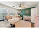 Charming bedroom with a daybed, a ceiling fan, a decorative green wall, and a crib at 3618 Berkeley Ct # Iv-A, Duluth, GA 30096