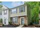 Charming townhouse with brick accents, blue shutters, and landscaped front yard with walkway at 3618 Berkeley Ct # Iv-A, Duluth, GA 30096