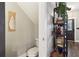 Hallway featuring stylish decor, a decorative bookshelf, and a doorway to a half-bath and the front entry at 3618 Berkeley Ct # Iv-A, Duluth, GA 30096