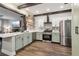 Bright open kitchen with stainless steel appliances, island seating, and updated fixtures, connecting to the living area at 3618 Berkeley Ct # Iv-A, Duluth, GA 30096