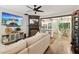 Open-concept living room featuring a fireplace with TV and a view into the kitchen and dining area at 3618 Berkeley Ct # Iv-A, Duluth, GA 30096