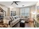 Comfortable living room features a large sectional sofa, ceiling fan, and access to the staircase at 3618 Berkeley Ct # Iv-A, Duluth, GA 30096