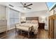 Comfortable primary bedroom with hardwood floors, ceiling fan, and stylish furniture at 3618 Berkeley Ct # Iv-A, Duluth, GA 30096