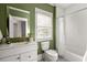 Full bathroom with white subway tile, a white vanity, and green painted walls at 604 Mead Se St, Atlanta, GA 30312