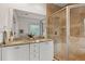 Modern bathroom featuring double sinks, granite countertops, and a glass-enclosed tile shower at 604 Mead Se St, Atlanta, GA 30312