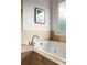 Close-up of a white tiled bathtub with a window that provides natural light at 604 Mead Se St, Atlanta, GA 30312