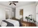 Bright primary bedroom featuring a view of the en-suite bathroom and walk-in closet with wood flooring at 604 Mead Se St, Atlanta, GA 30312