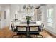 Elegant dining room with hardwood floors, stylish chandelier, and seating for six at 604 Mead Se St, Atlanta, GA 30312