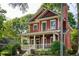 Lovely two-story home with a red exterior, a cozy front porch and chimney at 604 Mead Se St, Atlanta, GA 30312