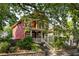 Charming two-story red home with inviting front porch and well-manicured landscaping at 604 Mead Se St, Atlanta, GA 30312
