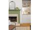 Cozy fireplace with a green mantle, built in shelving and hardwood flooring at 604 Mead Se St, Atlanta, GA 30312