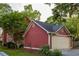 Detached garage with a large driveway surrounded by lush landscaping at 604 Mead Se St, Atlanta, GA 30312
