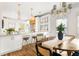 Bright eat-in kitchen featuring a large island, white cabinets and updated lighting fixtures at 604 Mead Se St, Atlanta, GA 30312