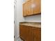 Laundry room featuring wooden cabinets, granite countertops, and modern patterned flooring at 604 Mead Se St, Atlanta, GA 30312