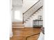 Elegant staircase with wooden treads, decorative iron railings, and hardwood floors at 604 Mead Se St, Atlanta, GA 30312
