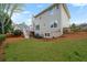 Expansive backyard view featuring a deck, lawn, and partial home elevation at 7010 Beloit Pl, Roswell, GA 30075