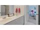 Bathroom with double sinks and modern hardware; bedroom visible in the background at 7010 Beloit Pl, Roswell, GA 30075