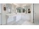Main bath with dual sinks, tile floor and soaking tub adjacent to the shower at 7010 Beloit Pl, Roswell, GA 30075