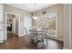 Cozy breakfast nook with natural light, wood floors and seating for four at 7010 Beloit Pl, Roswell, GA 30075