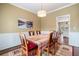 Elegant dining room with a decorative light fixture, tan walls, and stylish decor at 7010 Beloit Pl, Roswell, GA 30075
