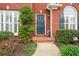 Charming brick home entrance with a well-maintained pathway and manicured bushes at 7010 Beloit Pl, Roswell, GA 30075