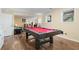 Basement game room features a pool table and wood laminate flooring at 7010 Beloit Pl, Roswell, GA 30075